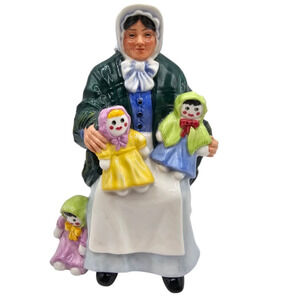 Vintage Royal Doulton ceramic figurine titled The Rag Doll Seller